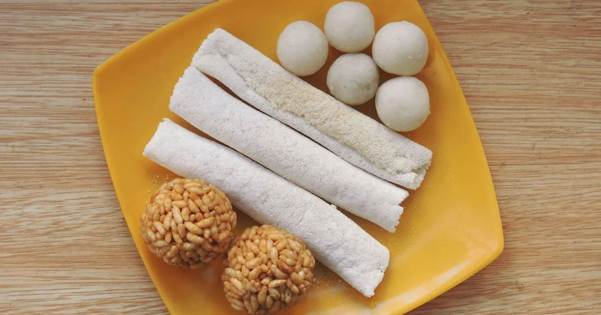 Til Pitha , an assamesse winter special food item with laddoos for food in train in winters